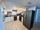 Well-lit kitchen with tile floors, stainless steel appliances, and modern finishes at 7719 Gaston Dr, Port Richey, FL 34668