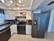 Updated kitchen featuring stainless steel appliances, white cabinets, and tile flooring at 7719 Gaston Dr, Port Richey, FL 34668