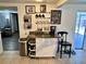 View of the kitchen area featuring a movable island, coffee bar and tile flooring at 7719 Gaston Dr, Port Richey, FL 34668