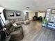 Comfortable living room with hardwood floors, a large sectional sofa, and natural light at 7719 Gaston Dr, Port Richey, FL 34668