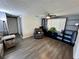 Cozy living room with hardwood floors, a ceiling fan, and built-in shelving at 7719 Gaston Dr, Port Richey, FL 34668