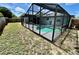 Backyard showcasing a screened-in pool at 7719 Gaston Dr, Port Richey, FL 34668