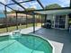 Inviting screened-in pool and patio area, perfect for relaxing and entertaining outdoors at 7719 Gaston Dr, Port Richey, FL 34668