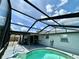 Backyard with a screened-in pool and patio at 7719 Gaston Dr, Port Richey, FL 34668