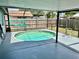 Screened-in pool area with a round pool and deck at 7719 Gaston Dr, Port Richey, FL 34668