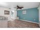 Comfortable bedroom with a ceiling fan, and an attached ensuite bathroom for added convenience at 8021 Wildflower Row, Hudson, FL 34667