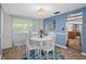 Cozy dining area featuring a round table with white chairs, colorful rug, and natural light at 8021 Wildflower Row, Hudson, FL 34667