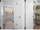 Hallway leading to bedroom with a bathroom across the hall at 8021 Wildflower Row, Hudson, FL 34667