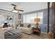 Inviting living room boasts a ceiling fan, comfortable sofa, and access to sunroom at 8021 Wildflower Row, Hudson, FL 34667