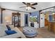 Cozy living room with a ceiling fan, comfortable sofa, and kitchen access at 8021 Wildflower Row, Hudson, FL 34667