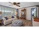 Relaxing living room featuring a ceiling fan, neutral sofa, and ample natural light at 8021 Wildflower Row, Hudson, FL 34667