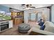 Open-concept living room with a ceiling fan, comfortable sofa, and adjacent kitchen at 8021 Wildflower Row, Hudson, FL 34667