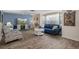 Inviting living room featuring wood-look floors, comfortable seating, and plenty of natural light at 8021 Wildflower Row, Hudson, FL 34667