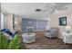 Bright living room with stylish wood flooring, cozy seating, and ample natural light at 8021 Wildflower Row, Hudson, FL 34667