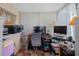 Bright home office with natural light, tiled floor, and desk with computer setup at 8021 Wildflower Row, Hudson, FL 34667