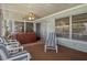 Inviting screened patio with hot tub, ceiling fan, sliding door access, and comfortable seating area at 8021 Wildflower Row, Hudson, FL 34667