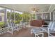 Covered patio boasts a hot tub, ceiling fan, and comfortable seating for outdoor relaxation at 8021 Wildflower Row, Hudson, FL 34667