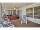 Covered patio with a hot tub, ceiling fan, sliding door access, and comfortable seating at 8021 Wildflower Row, Hudson, FL 34667