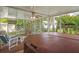 Screened in patio area featuring a jacuzzi, ceiling fan, lounge furniture and peaceful backyard at 8021 Wildflower Row, Hudson, FL 34667