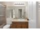 Bathroom with a classic vanity, large mirror, and shower with glass door at 8431 Spring Hill Dr, Spring Hill, FL 34608