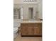 Bathroom with a classic vanity, large mirror, and an open doorway at 8431 Spring Hill Dr, Spring Hill, FL 34608