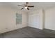 Bedroom featuring hardwood floors, a window, a ceiling fan, and a closet with white folding doors at 8431 Spring Hill Dr, Spring Hill, FL 34608