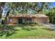 Charming single-story home featuring a well-maintained lawn and a covered front porch entrance at 8431 Spring Hill Dr, Spring Hill, FL 34608