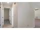 Hallway with neutral walls and tile floors leading to bedrooms, bathroom, or other living spaces at 8431 Spring Hill Dr, Spring Hill, FL 34608