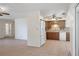 An open kitchen features wood cabinets, white appliances, and seamless flow into the adjacent living area at 8431 Spring Hill Dr, Spring Hill, FL 34608