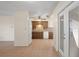 An open kitchen features wood cabinets, white appliances, and seamless flow into the adjacent living area at 8431 Spring Hill Dr, Spring Hill, FL 34608