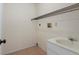 Functional laundry room with sink, tile flooring and wire shelving for easy storage at 8431 Spring Hill Dr, Spring Hill, FL 34608