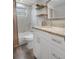 Modern bathroom featuring a granite vanity, marble tiled shower, and updated fixtures at 9111 Greenbriar Ln, Port Richey, FL 34668