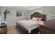 Comfortable bedroom with a large bed, hardwood floors, and ample natural light at 9111 Greenbriar Ln, Port Richey, FL 34668