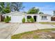 Charming single-story home with a well-maintained yard, arched entryway, and a one-car garage at 9111 Greenbriar Ln, Port Richey, FL 34668