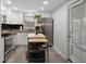 Bright kitchen with stainless steel appliances, white cabinetry, and convenient butcher block island at 9111 Greenbriar Ln, Port Richey, FL 34668