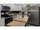 Bright kitchen with stainless steel appliances, modern cabinets, and a butcher block island at 9111 Greenbriar Ln, Port Richey, FL 34668