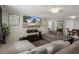 Cozy living room with large sectional sofa, mounted TV, and modern decor at 9111 Greenbriar Ln, Port Richey, FL 34668