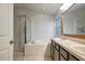 Bright bathroom featuring a double sink vanity, large mirror, and a separate tub and shower at 9527 Southern Charm Cir, Brooksville, FL 34613