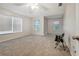 Spacious bedroom with neutral carpeting, a ceiling fan and windows offering natural light at 9527 Southern Charm Cir, Brooksville, FL 34613
