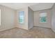 Bright bedroom with neutral carpet and windows provides abundant natural light at 9527 Southern Charm Cir, Brooksville, FL 34613