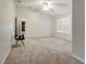 Large bedroom features neutral carpet, ceiling fan, and window at 9527 Southern Charm Cir, Brooksville, FL 34613