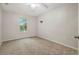 Bright bedroom with carpet flooring, a ceiling fan, and a window offering natural light at 9527 Southern Charm Cir, Brooksville, FL 34613