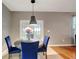Cozy dining area with elegant table and blue chairs beneath a modern pendant light at 9527 Southern Charm Cir, Brooksville, FL 34613