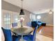 Inviting dining area with a stylish table and comfortable seating near a sunlit living room at 9527 Southern Charm Cir, Brooksville, FL 34613