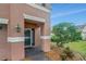 Close up of two-story home featuring front door and manicured front lawn at 9527 Southern Charm Cir, Brooksville, FL 34613
