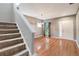 Spacious, well-lit living room with hardwood floors and stairs at 9527 Southern Charm Cir, Brooksville, FL 34613