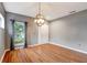 Spacious, well-lit living room with hardwood floors, neutral color palette, and stylish lighting at 9527 Southern Charm Cir, Brooksville, FL 34613