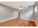 Spacious, well-lit living room with hardwood floors and stairs at 9527 Southern Charm Cir, Brooksville, FL 34613