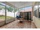Enclosed patio with an egg chair provides a relaxing space for reading and enjoying the outdoors at 9527 Southern Charm Cir, Brooksville, FL 34613