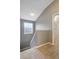 Carpeted staircase with a window providing natural light, leading to the upper level at 9527 Southern Charm Cir, Brooksville, FL 34613